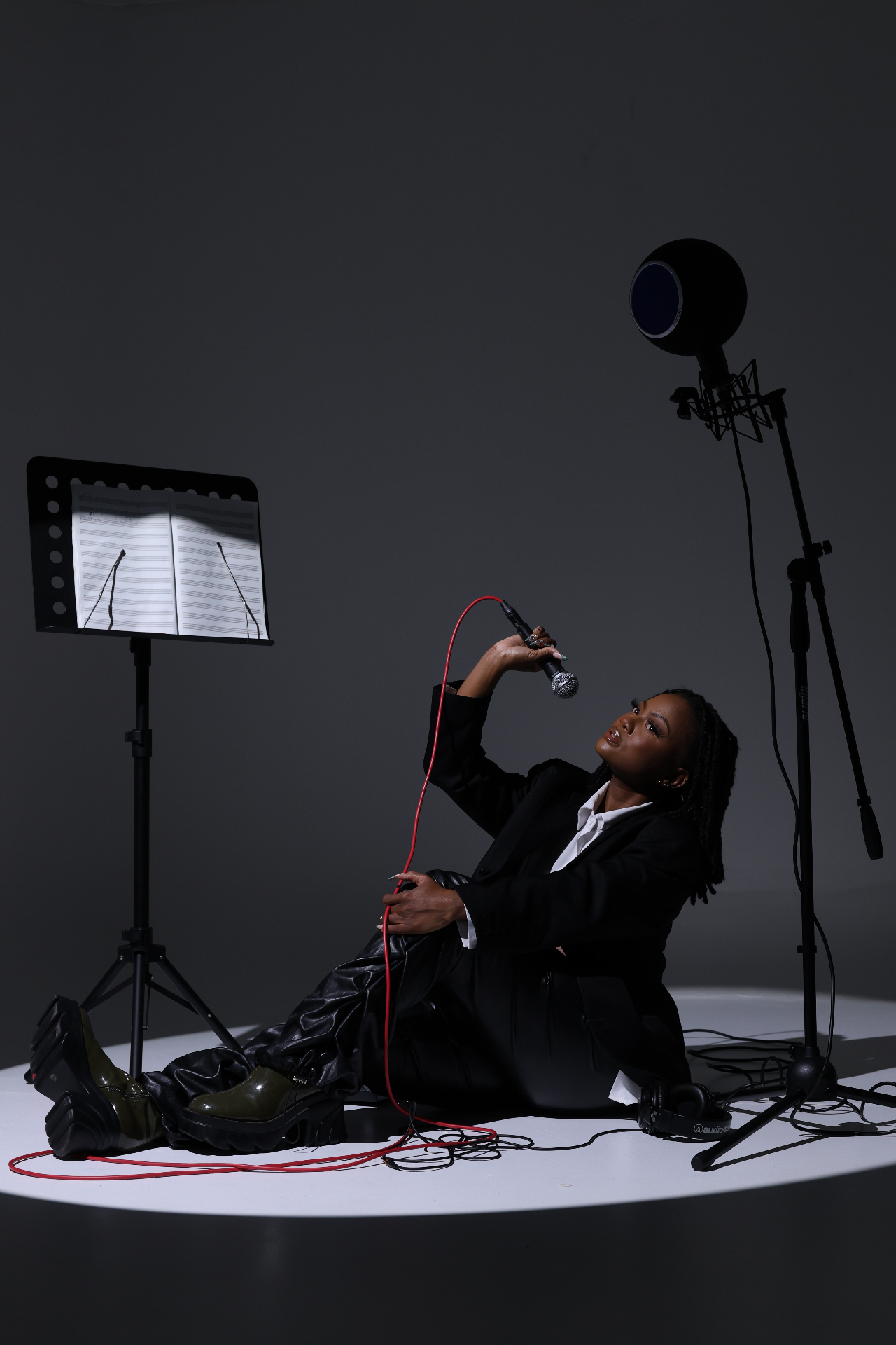 Studio portrait holding a microphone